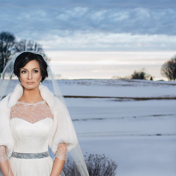 bride in a snowy feild looking away